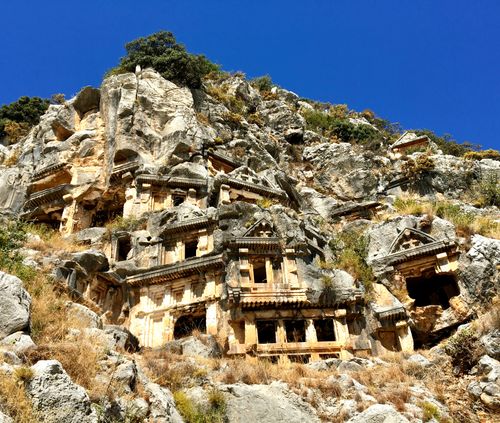 Free Ancient Lycian rock tombs carved into cliffs in Fethiye, Türkiye. Stock Photo