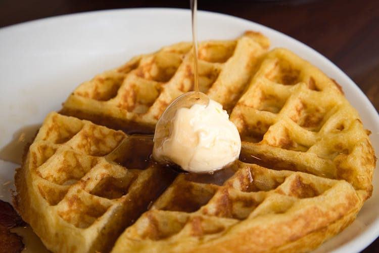 Close-Up Shot Of A Waffle With Butter And Syrup