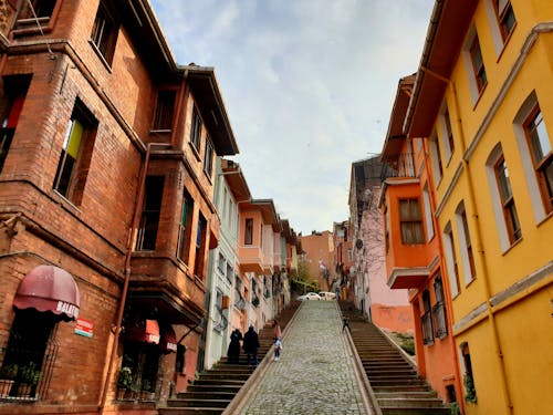 People Walking on Street Between Buildings