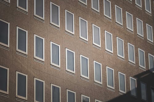 Free Brown Concrete Building with White Frame Glass Windows Stock Photo