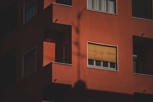 Close-up of a modern apartment building facade with shadow contrasts.