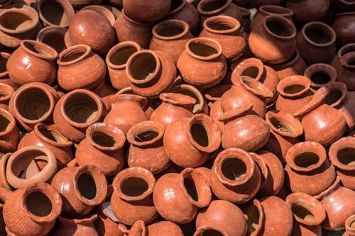 Free A collection of handmade clay pots displayed in an outdoor market in Mandalay, Myanmar. Stock Photo