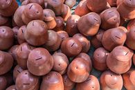 Aerial view of artisanal clay pots in an outdoor market in Mandalay, Myanmar.