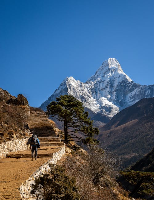 Person Hiking on Ama Dablam Mountains in Nepal