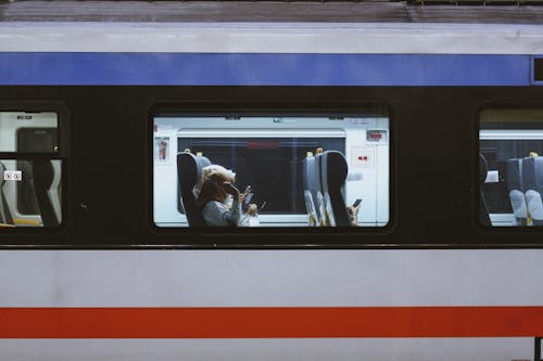 People Sitting Inside a Bus Using Cellphones