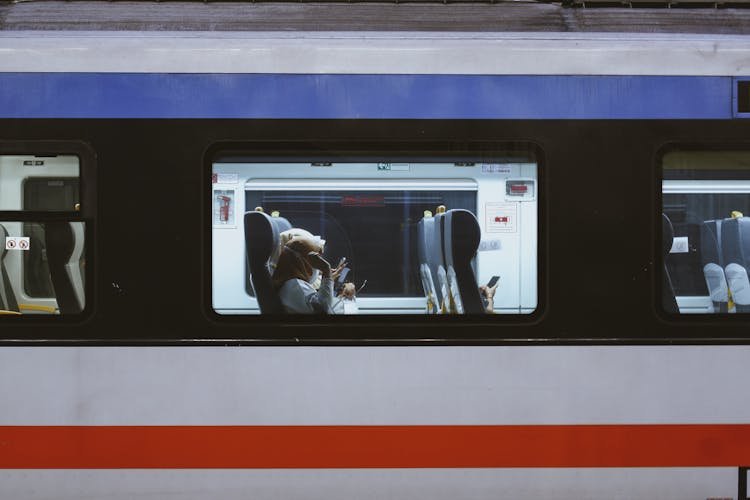 People Sitting Inside A Bus Using Cellphones