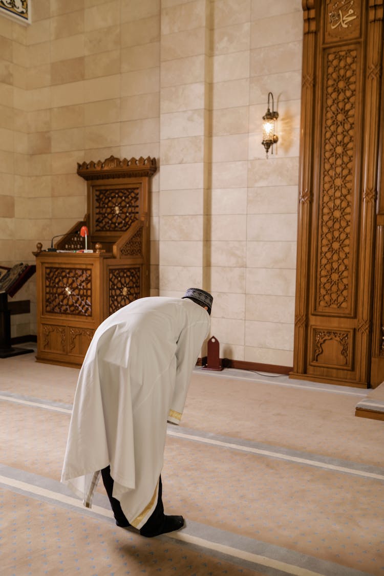 Man Bowing Inside A Mosque