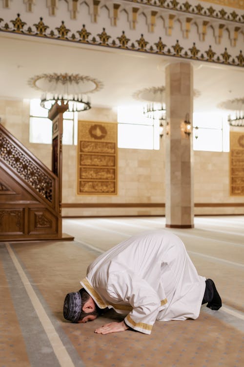 A Man in White Thobe Bowing