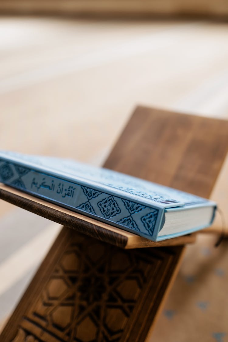 Brown Wooden Book Stand And A Blue Book