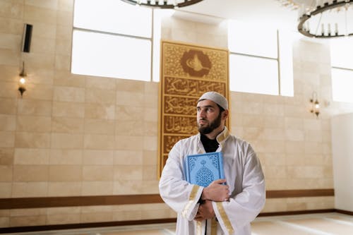 Portrait of Man with Koran at Mosque