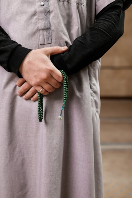 A Person Holding a Prayer Beads