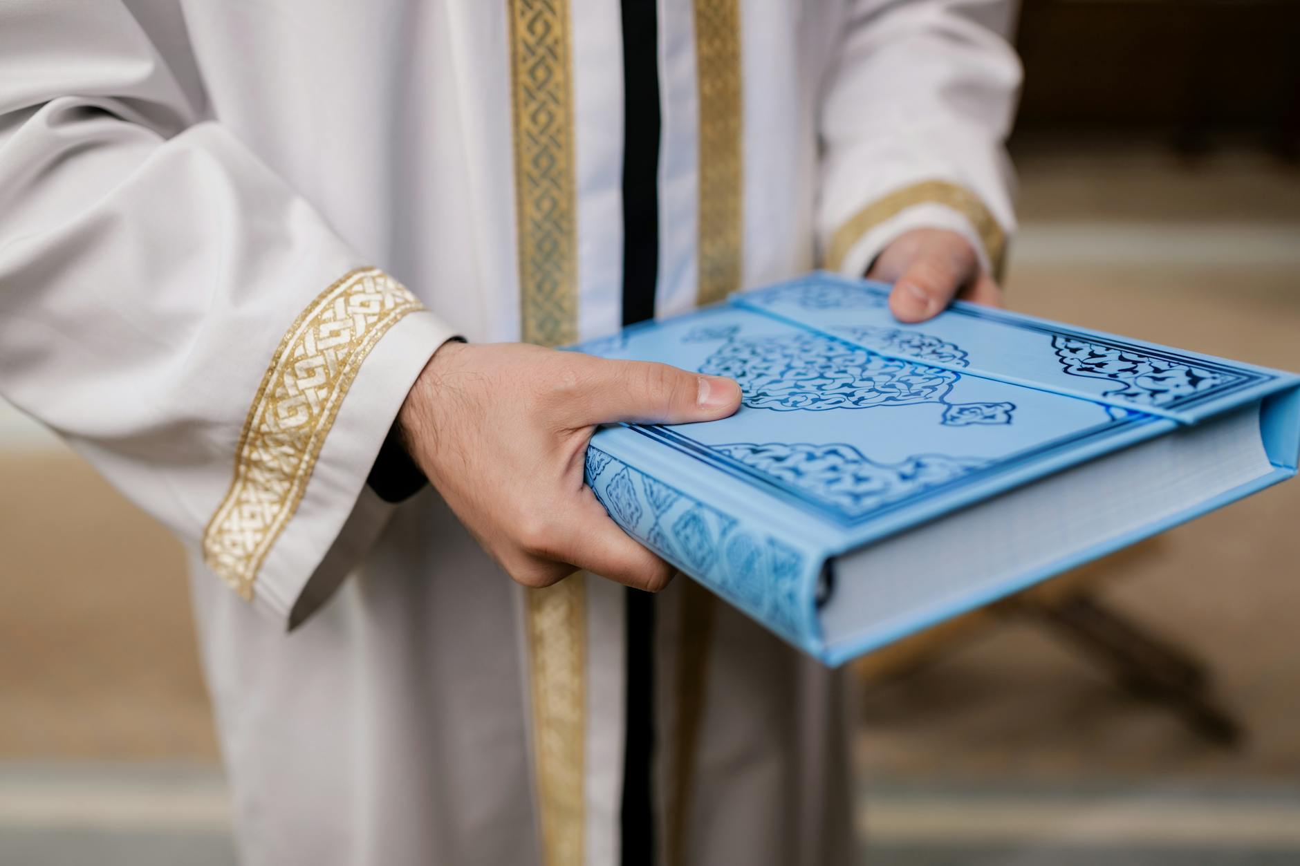 https://www.pexels.com/photo/holding-a-koran-8164512/