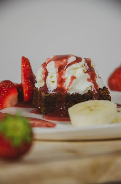 Piece of Chocolate Cake with Ice Cream and Strawberry Sauce