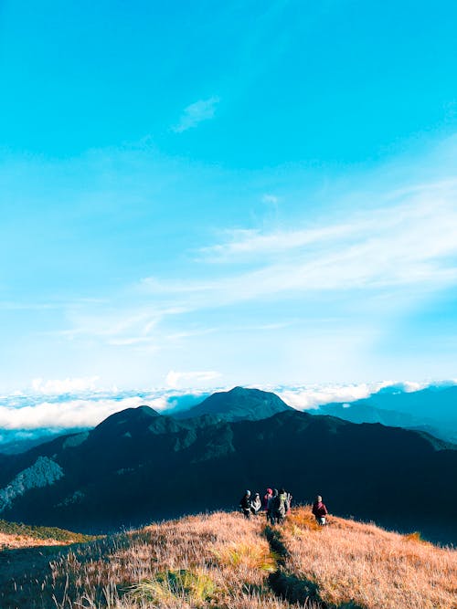 Free People Walking on Top of Mountain Stock Photo