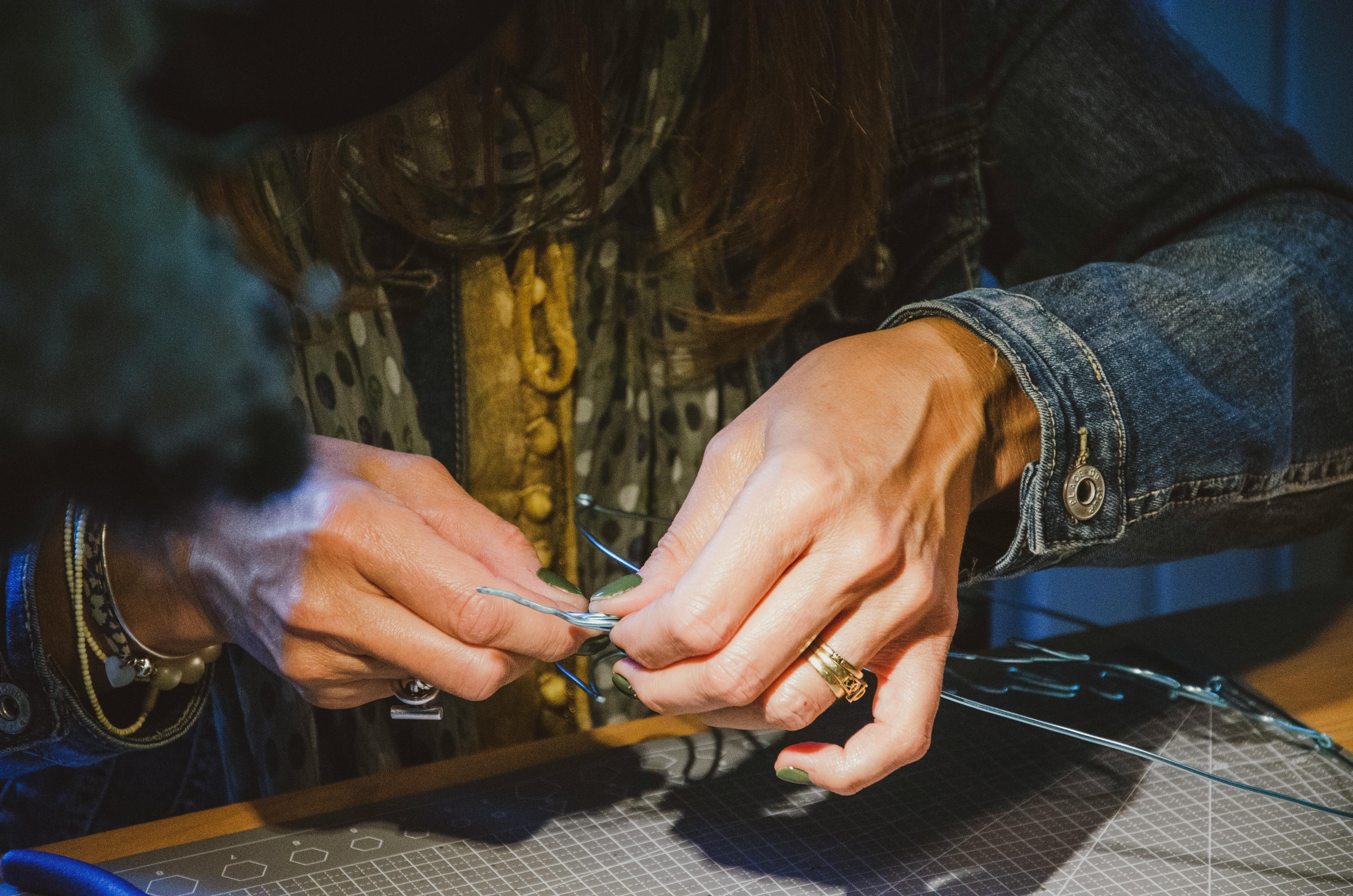 a jeweler's hands carefully working on a piece of jewelry - fine jewelry Washington DC