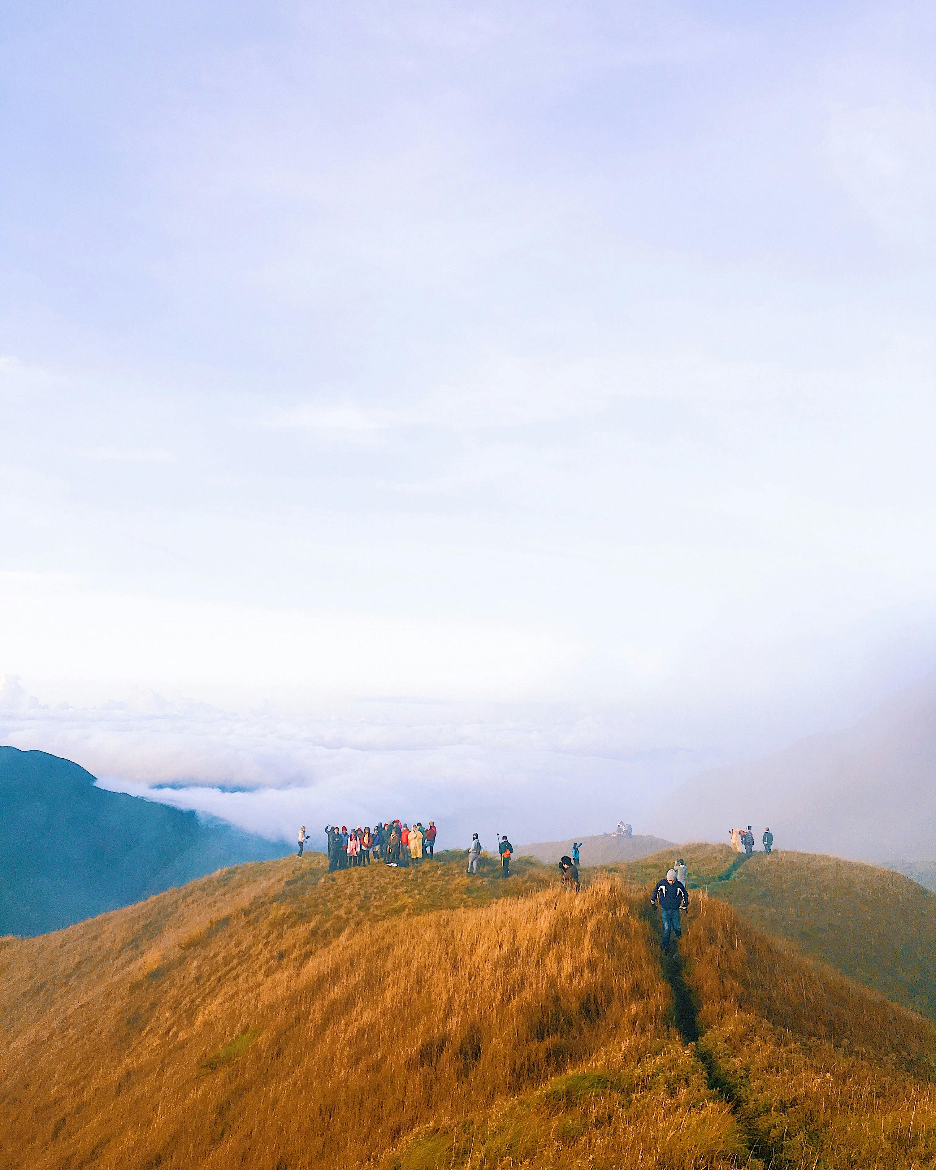 People Standing on Brown Hill · Free Stock Photo