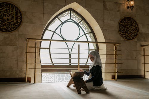 Girl Reading Quran inside a Mosque