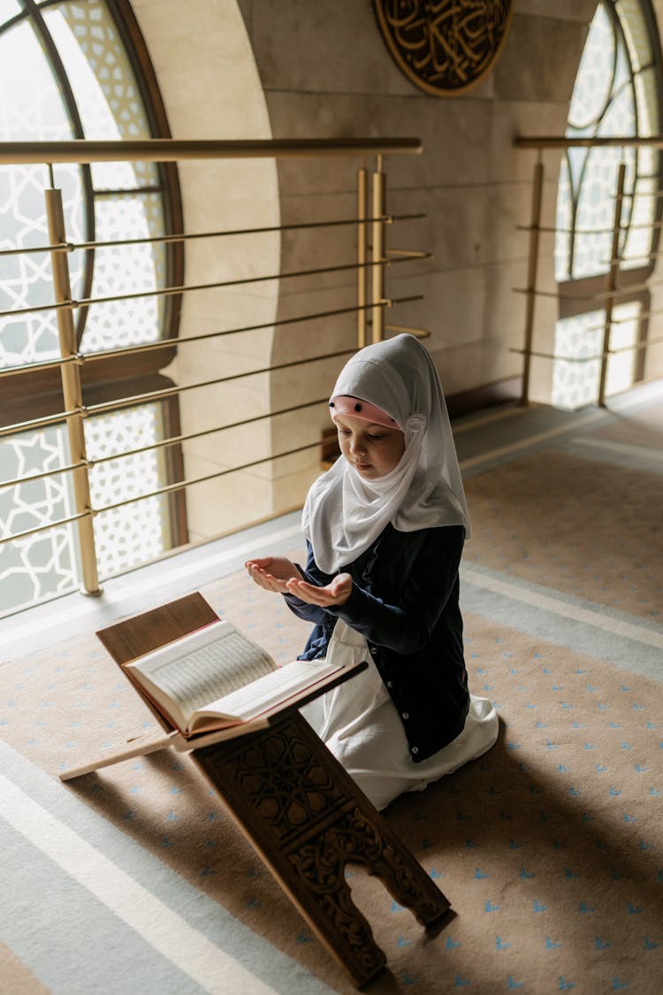 Girl In White Hijab And Black Long Sleeves Praying