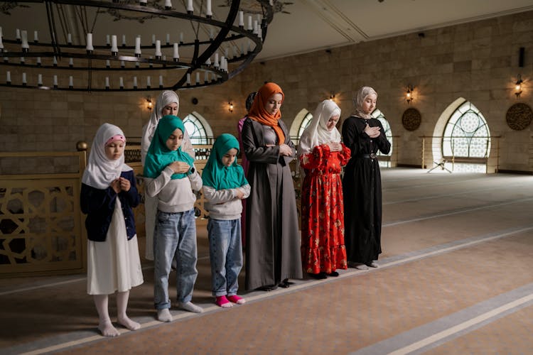 Group Of Women Standing While Praying