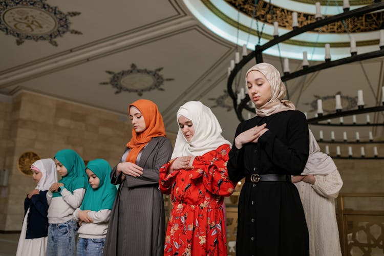 Group Of Women And Children Praying On The Balcony In The Mosque