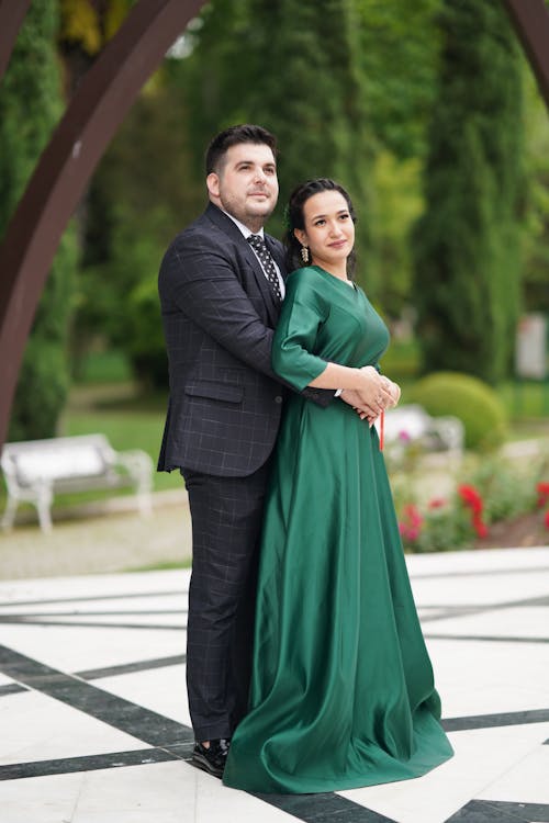 Couple Standing on a Tiled Floor in the Garden Wearing Formal Dress