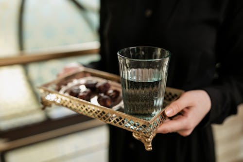 Glass of Water in a Metallic Serving Tray