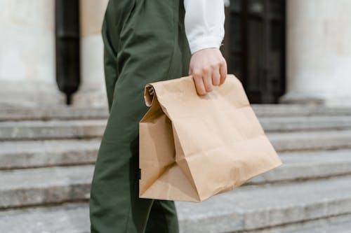 Person Holding a Brown Paper Bag