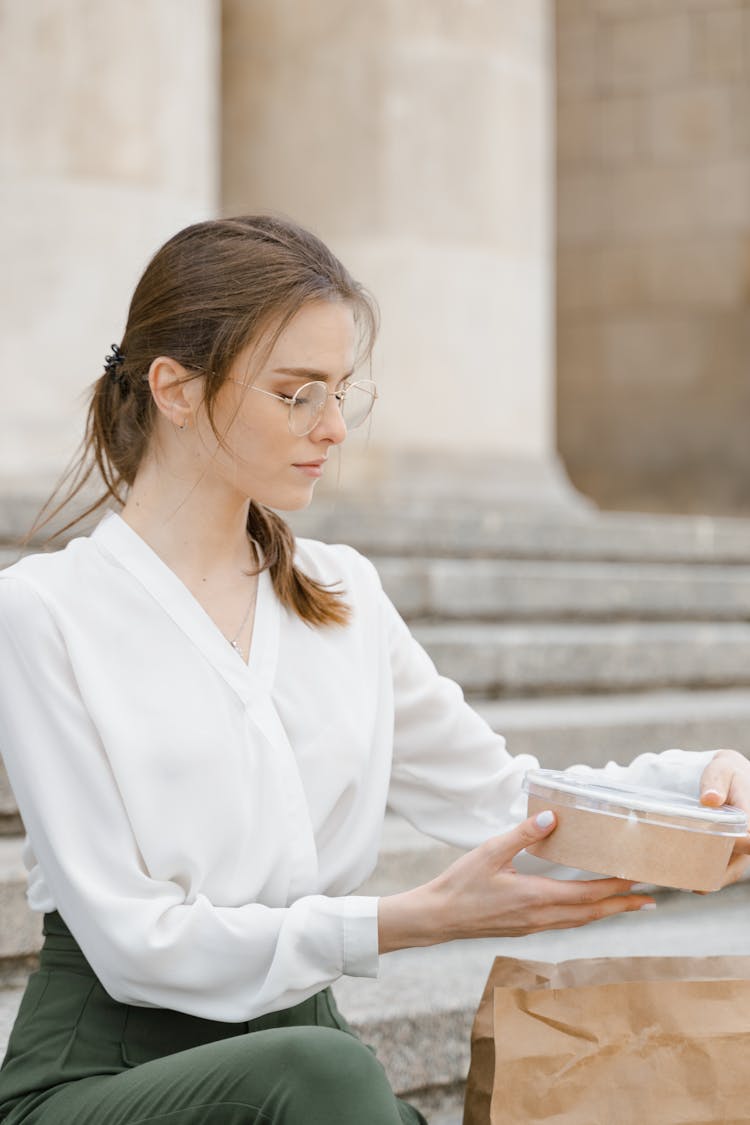 Woman In White Long Sleeve Shirt Holding A Take Out Food