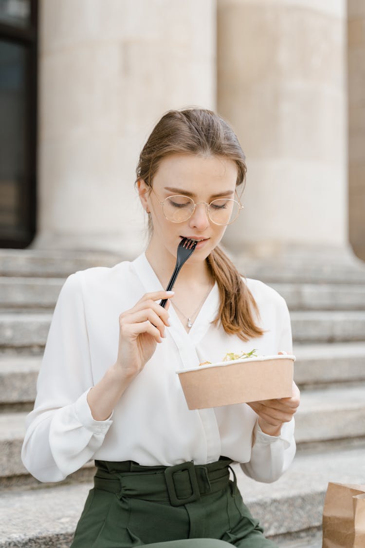 Woman Holding A Plastic Fork And Take Out Food