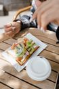 Person Eating a Fruit Pie on a Wooden Table