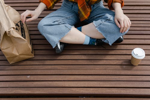 Kostenloses Stock Foto zu beine überkreuzt, einwegbecher, frau