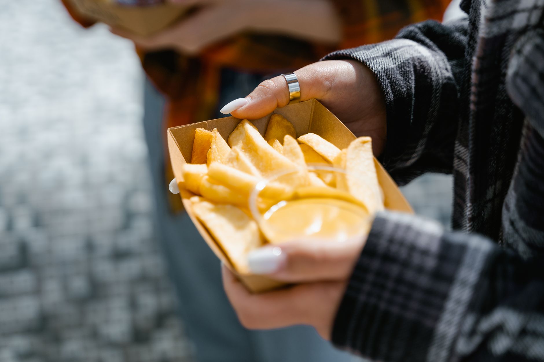 Waffle cut french fries served in a red fast food container with dipping sauce