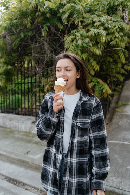 Woman in Plaid Shirt Eating Ice Cream