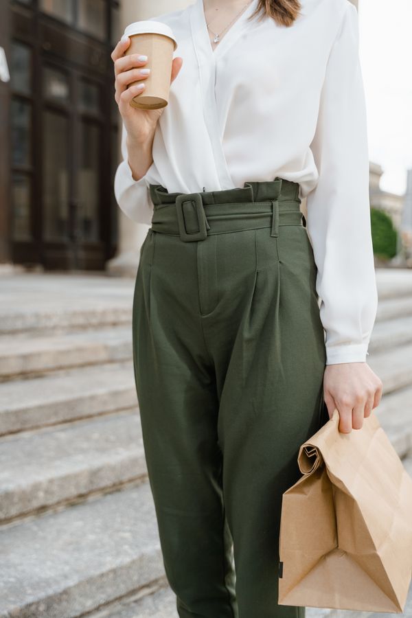 Woman in paperbag waist trousers with ribbed top