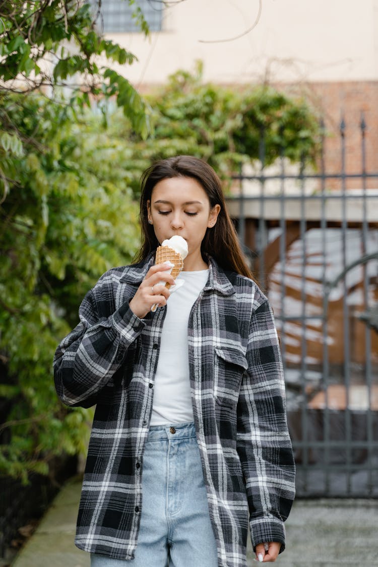 Young Woman Eating Vanilla Ice Cream