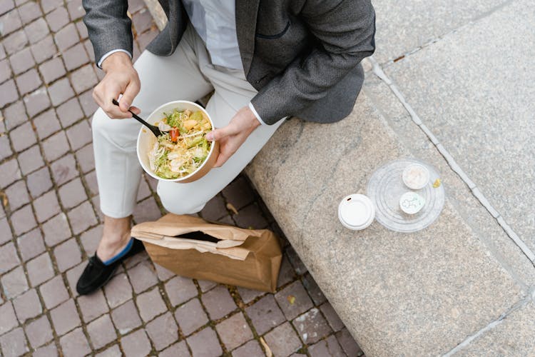 Man Eating A Bowl Of Vegetable Salad