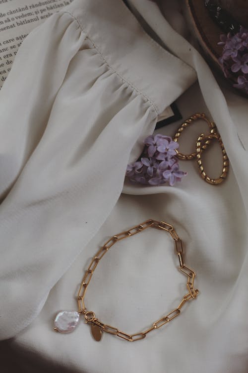 
Golden Accessories over a White Cloth