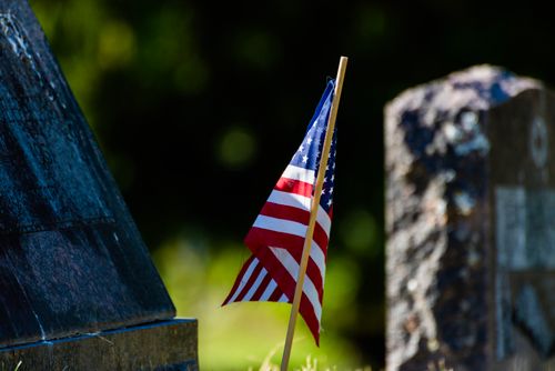 Free American flag at a cemetery, symbolizing honor and remembrance. Stock Photo