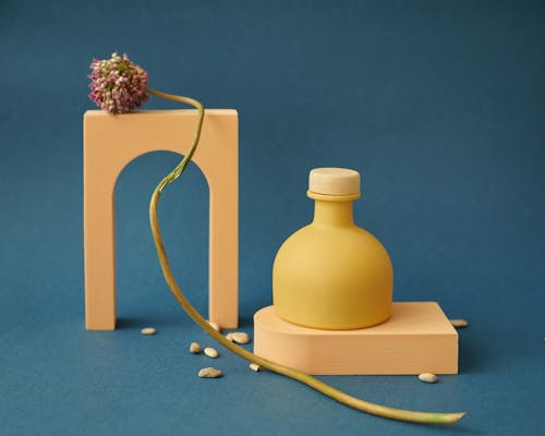 Yellow Ceramic Bottle on Blue Background