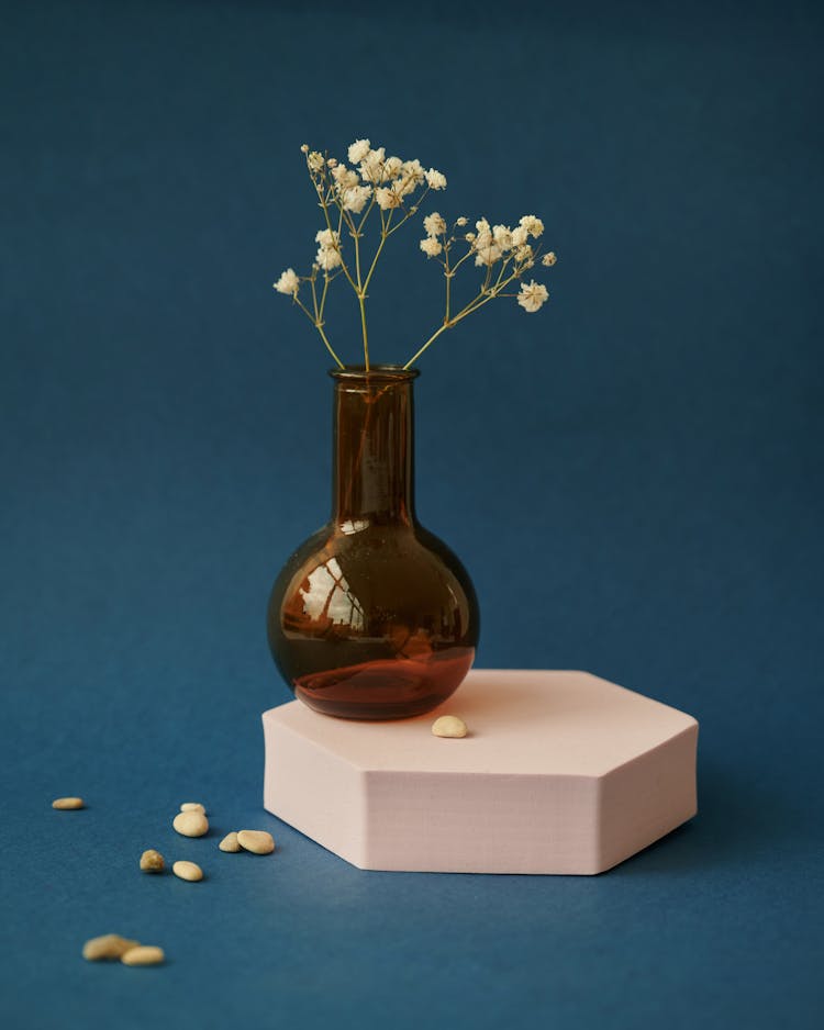 
A Vase Of Flowers On A Hexagon Platform