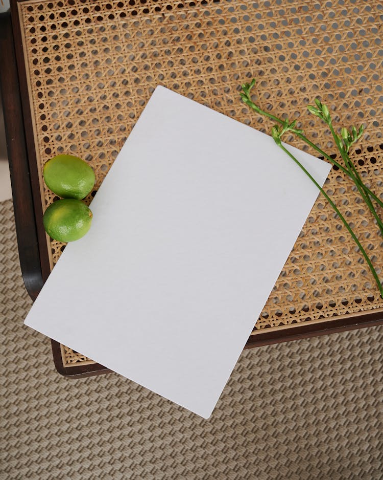 
A Blank Paper On A Woven Cane Chair