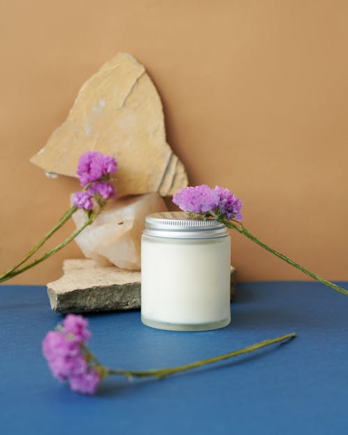 Photo of a Jar and Purple Flowers