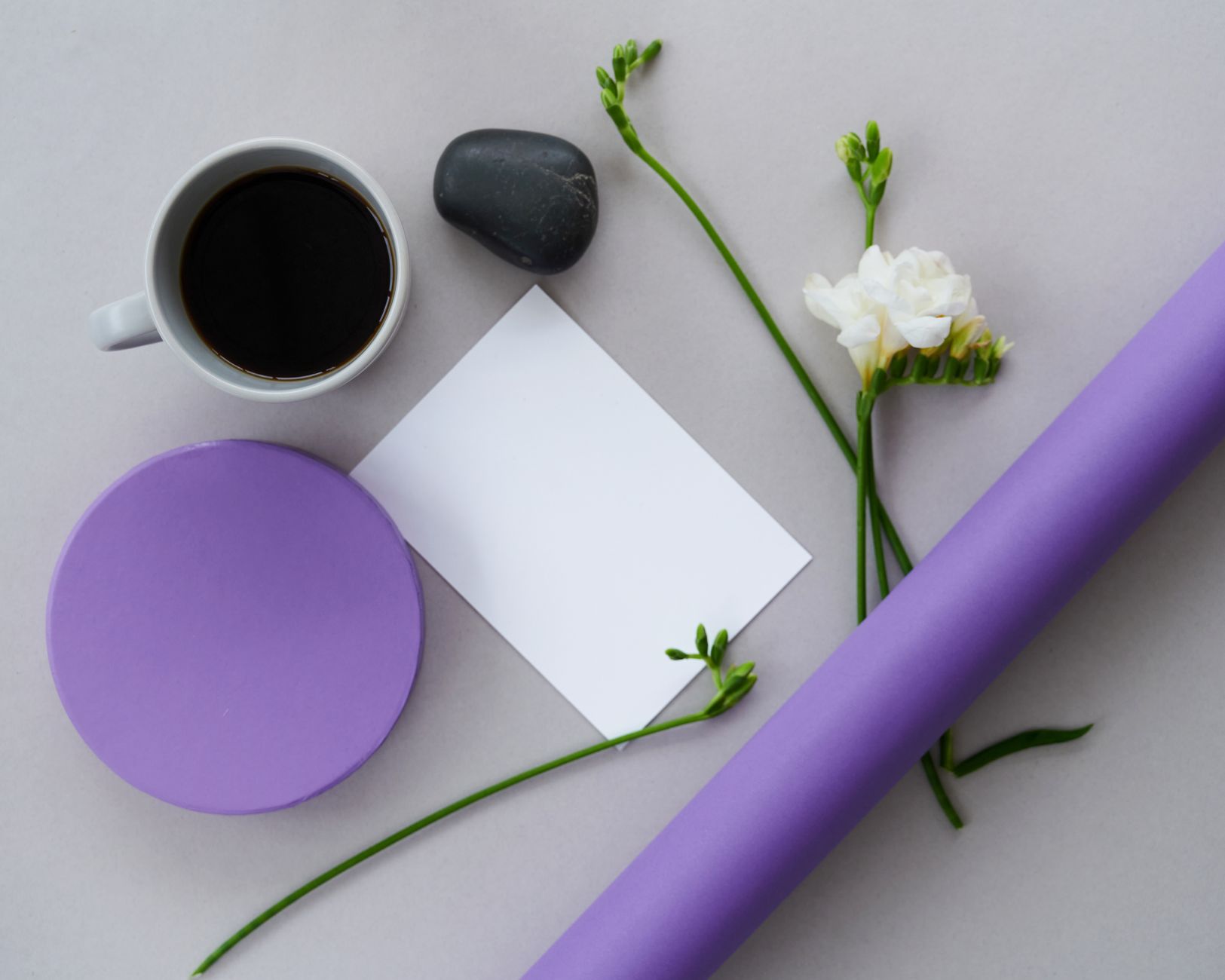 Aesthetic flat lay featuring coffee, white flowers, a note, and a purple arrangement on a white background.. pexels, aestheti