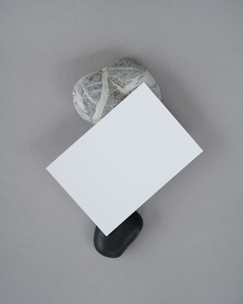 Blank Paper Sheet on Two Rocks 