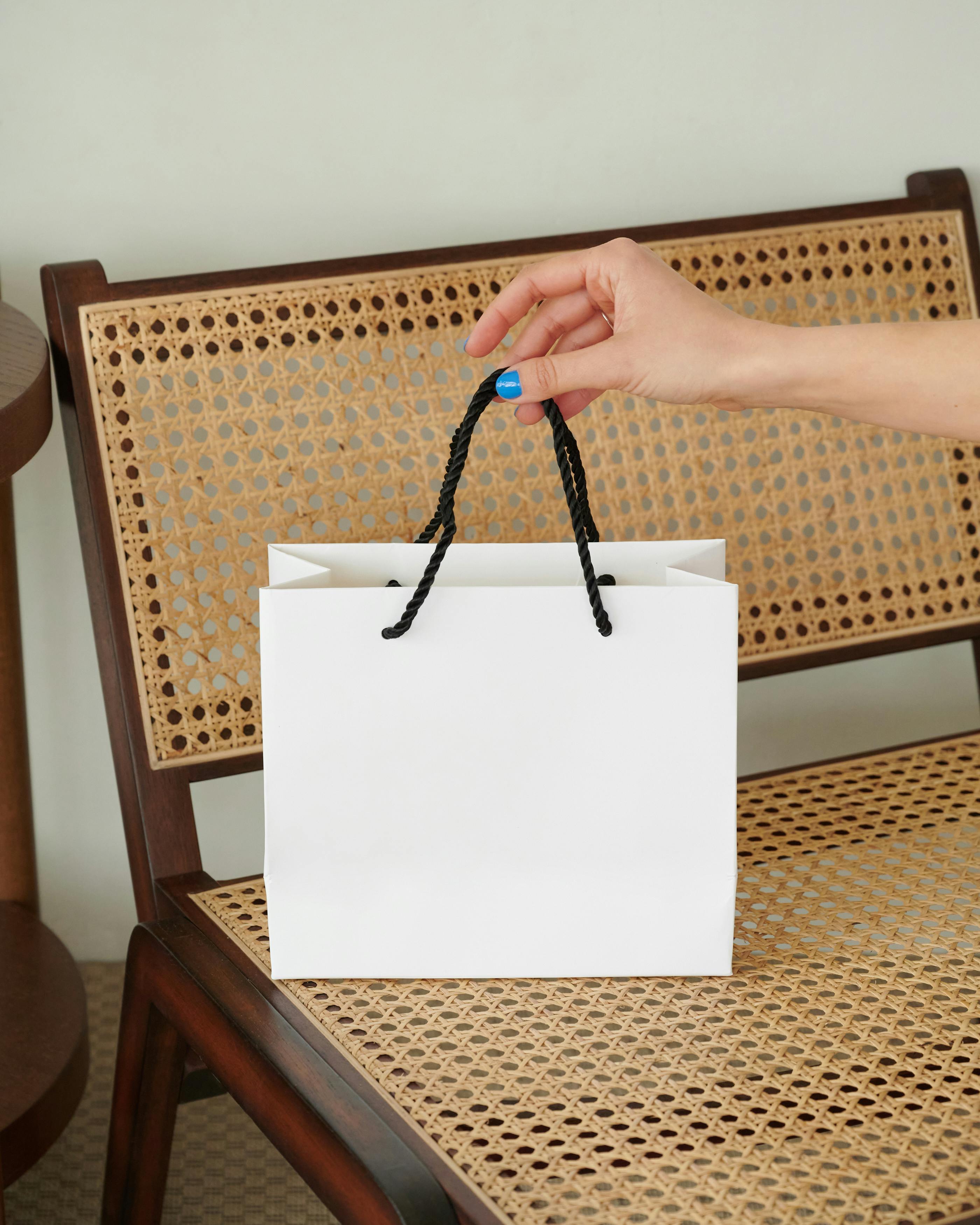 a person holding a paper bag