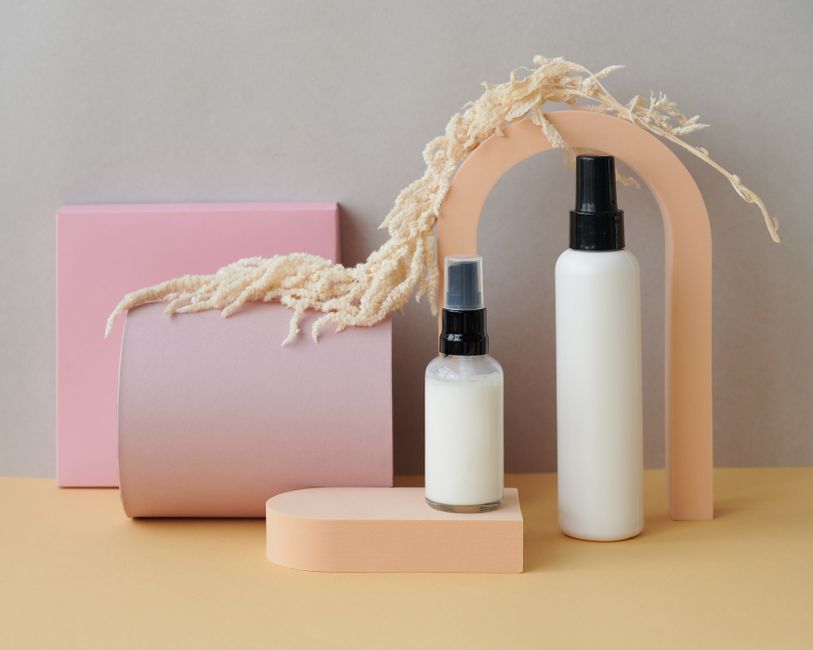 Stylish display of perfume bottles with geometric shapes and soft colors, ideal for product showcases.