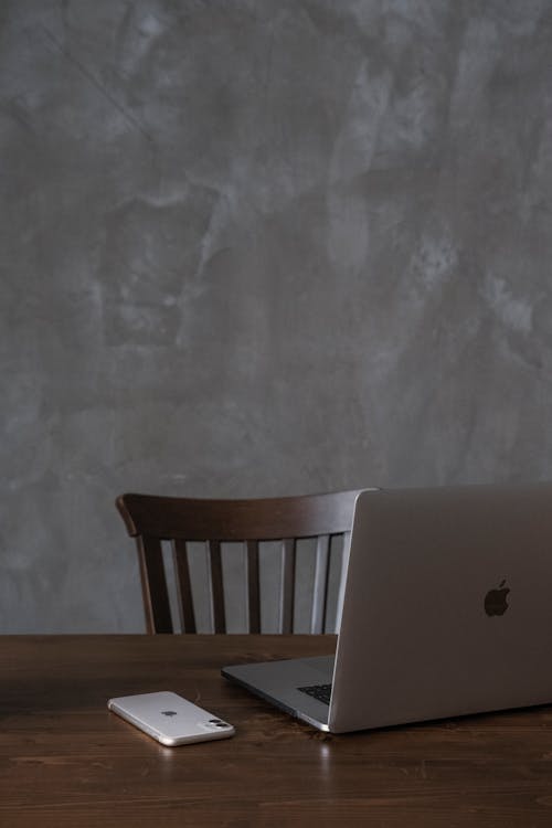 Laptop and smartphone placed on table