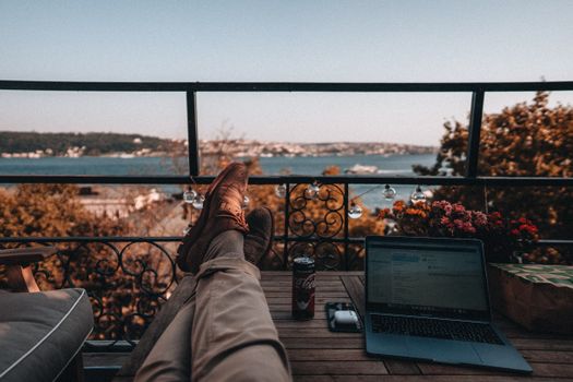 Enjoy a tranquil work-from-home setup with a serene balcony view and essentials.