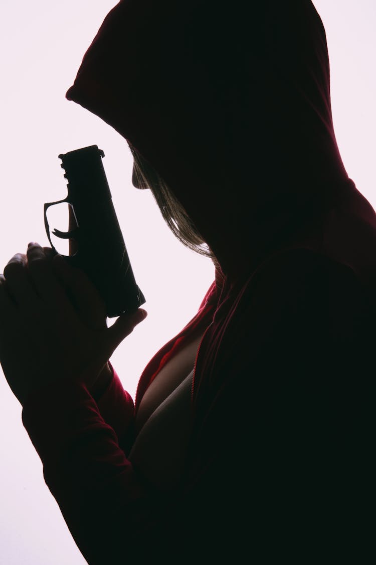 Silhouette Of A Person Holding A Gun