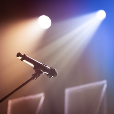 Microphone on a stand against concert lighting - photo by Brett Sayles on Pexels